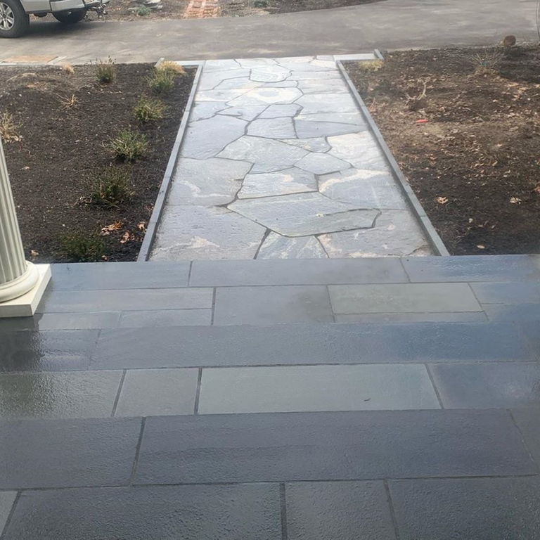 The image shows this material being used in a path pavers application.