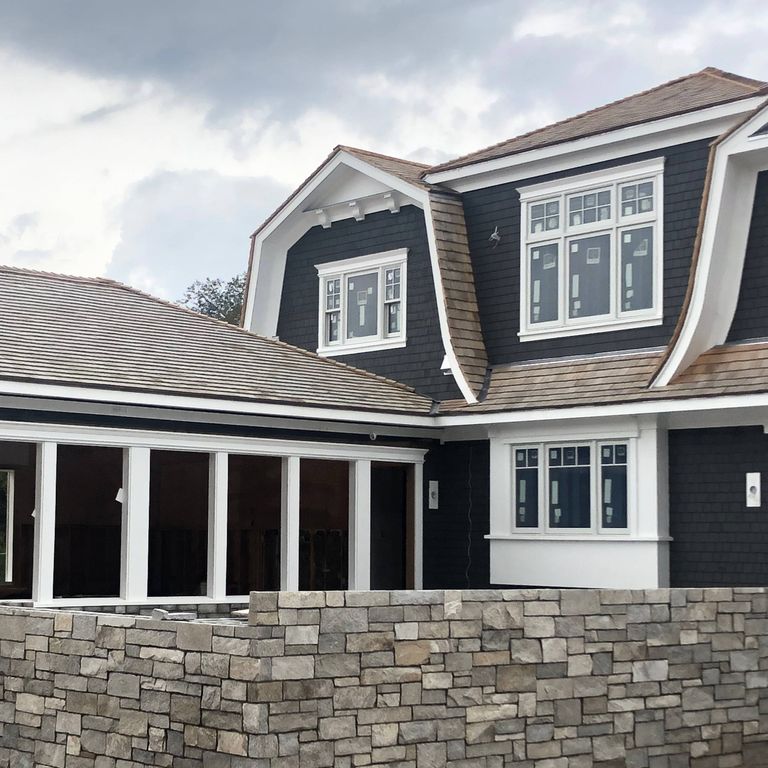 Application image for Harbor Mist Granite. The image shows this material being used for full bed veneer and thin veneer. The dominant color shown is gray. The color mix creates a warm feeling. Regular color pattern.