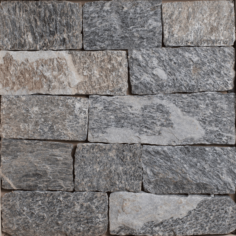 Close-up image for Bergen Blend Granite. The surface finish shown is split-face. The dominant color shown is gray; with blue, brown, green and purple secondaries. Exhibits 