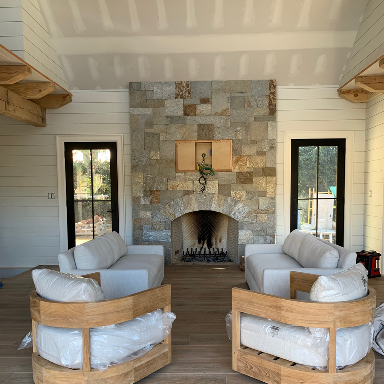 Application image for Granite - Spruce Mountain. The image shows this material being used for fireplace mantel, full bed veneer, thin veneer and interior cladding. Dominant colors shown are brown and tan. The color mix creates a warm feeling.