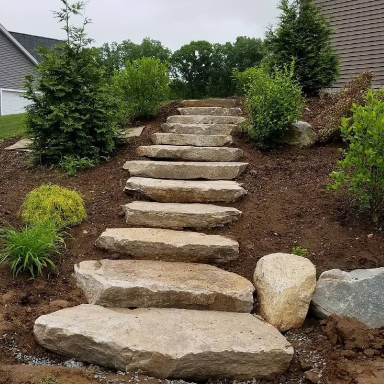 Application image for Colonial Tan Granite. The image shows this material being used in a monolithic steps application. This is a building and landscape stone for indoor and outdoor commercial and residential applications. Suitable for general use, freeze-thaw conditions, low heat absorption surfaces and low slipperiness surfaces situations. Relatively moderate in price.