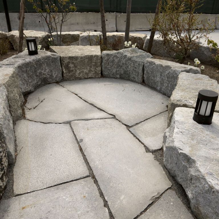The image shows this material being used in a patio pavers application.
