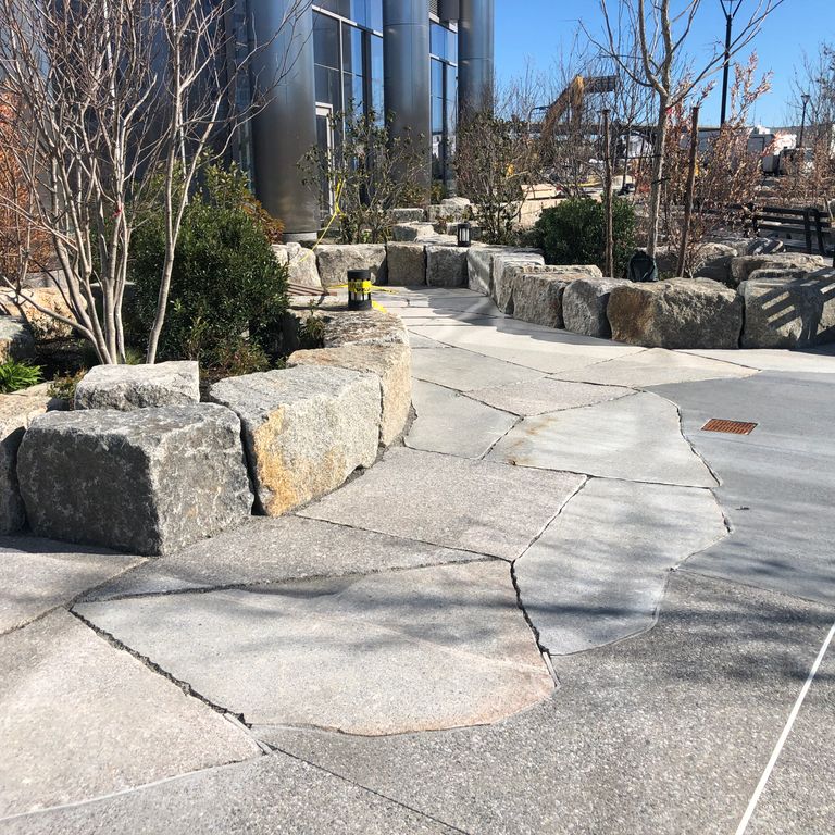 The image shows this material being used in a patio pavers application.