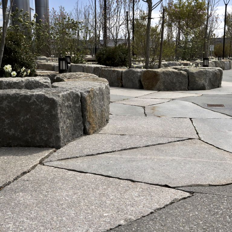 The image shows this material being used in a patio pavers application.