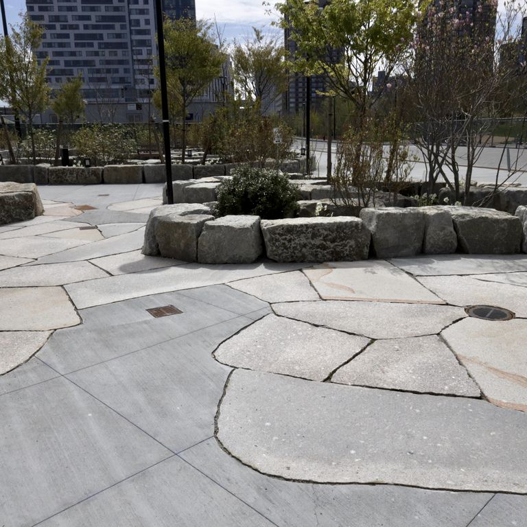 The image shows this material being used in a patio pavers application.