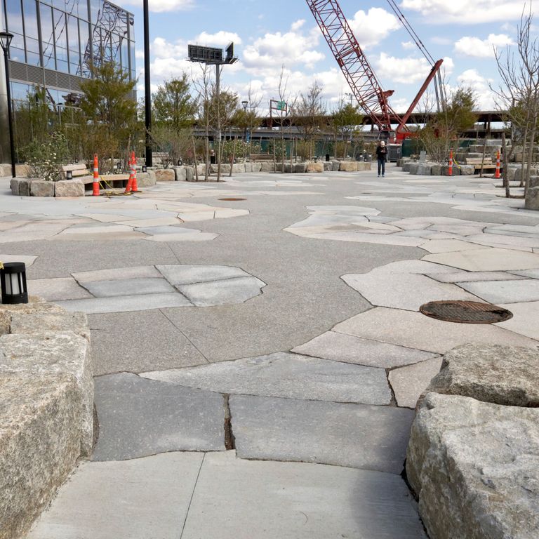 The image shows this material being used in a patio pavers application.