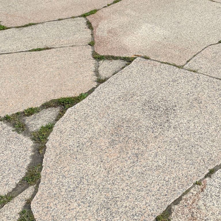 Close-up image for Millenium Granite. The surface finish shown is polished. Dominant colors shown are beige and tan; with gray and cream secondaries. Exhibits 