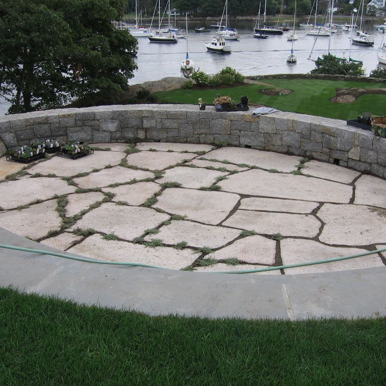 Application image for Millenium Granite. The image shows this material being used in a patio pavers application. The surface finish shown is flamed. Dominant colors shown are gray and pink. The color mix creates a cool feeling. Regular color pattern.