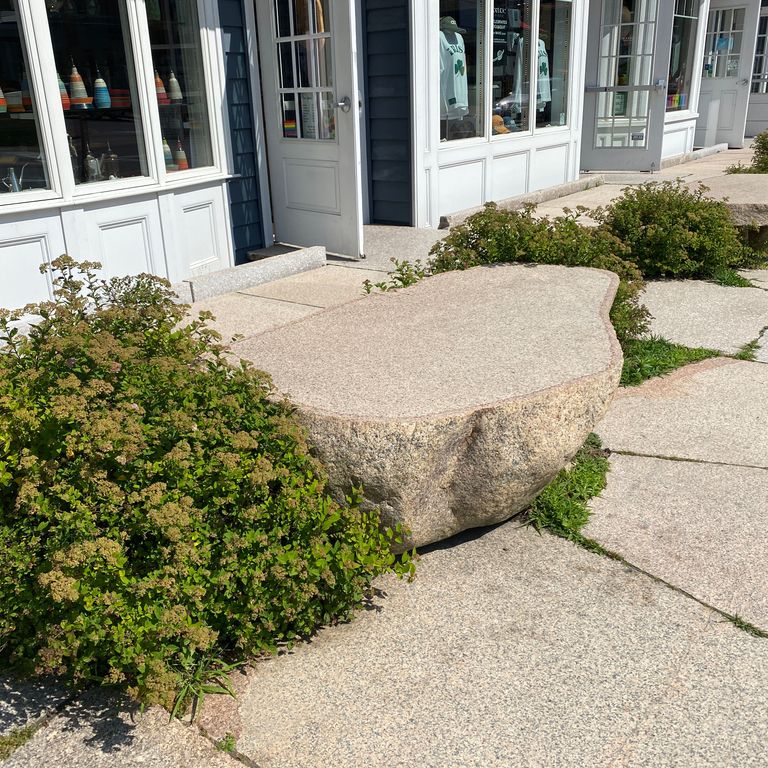 Application image for Millenium Granite. The image shows this material being used for seating & benches and patio pavers. The surface finish shown is a combination of flamed and natural. Dominant colors shown are beige, gray, tan and cream. Speckled color pattern.