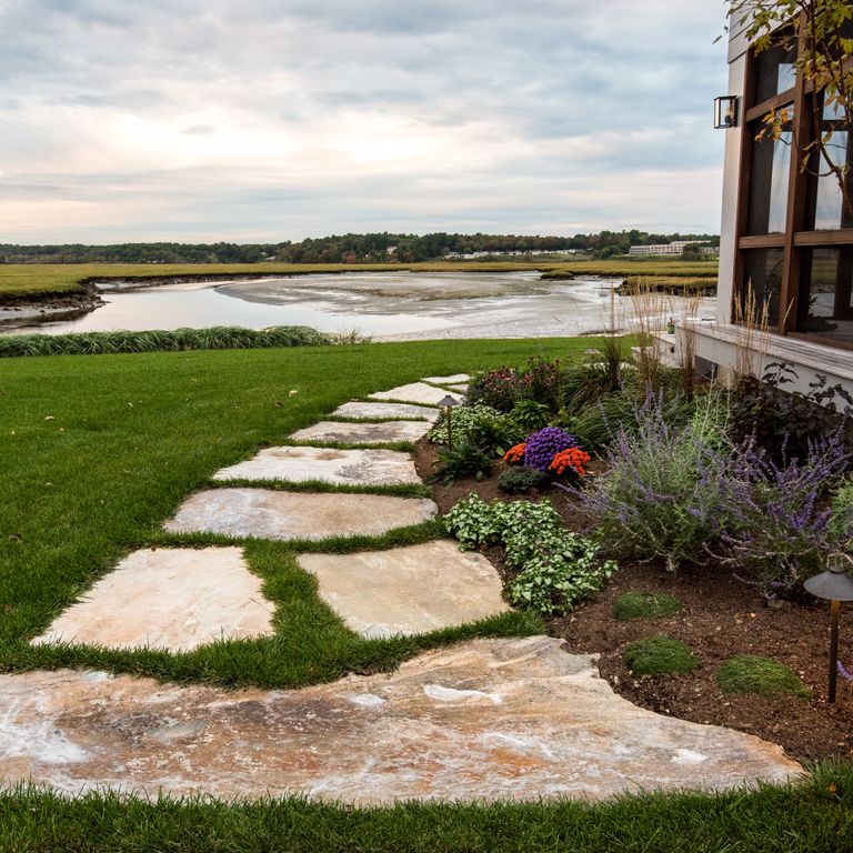 The image shows this material being used in a path pavers application. Dominant colors shown are beige and brown. The color mix creates a warm feeling. Random color pattern.