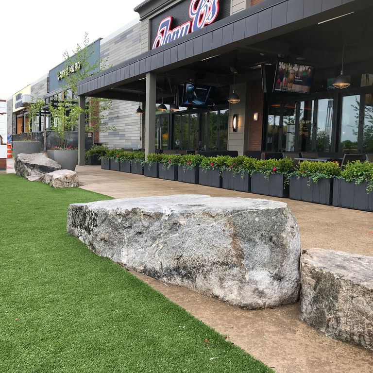 The image shows this material being used for garden accents, seating & benches and landscape boulders & ledge. Dominant colors shown are gray and white; with beige and black secondaries.