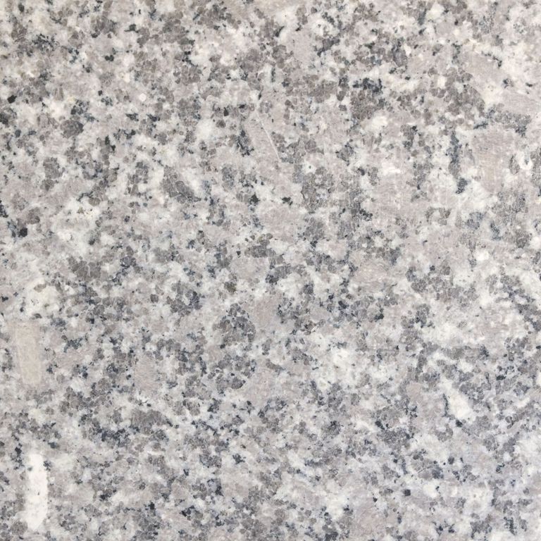 Color/Finish variation image for Deer Isle Granite. The surface finish shown is honed. Dominant colors shown are gray and pink. The color mix creates a cool feeling. Coarse speckled color pattern.
