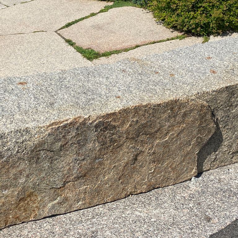 Application image for Deer Isle Granite. The image shows this material being used in a seating & benches application. The surface finish shown is . Dominant colors shown are beige, gray, pink and tan. The color mix creates a warm feeling. Speckled color pattern.