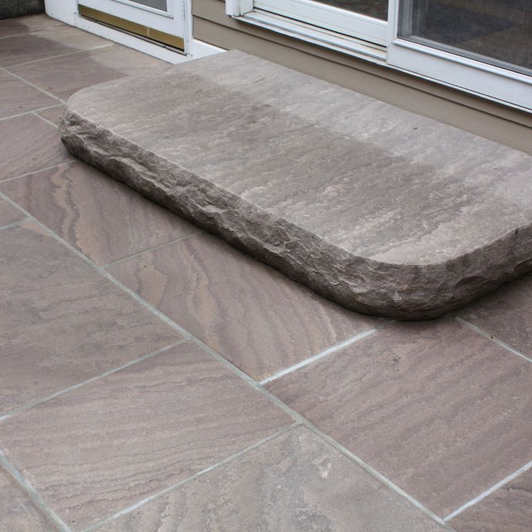 The image shows this material being used for patio pavers and monolithic steps.