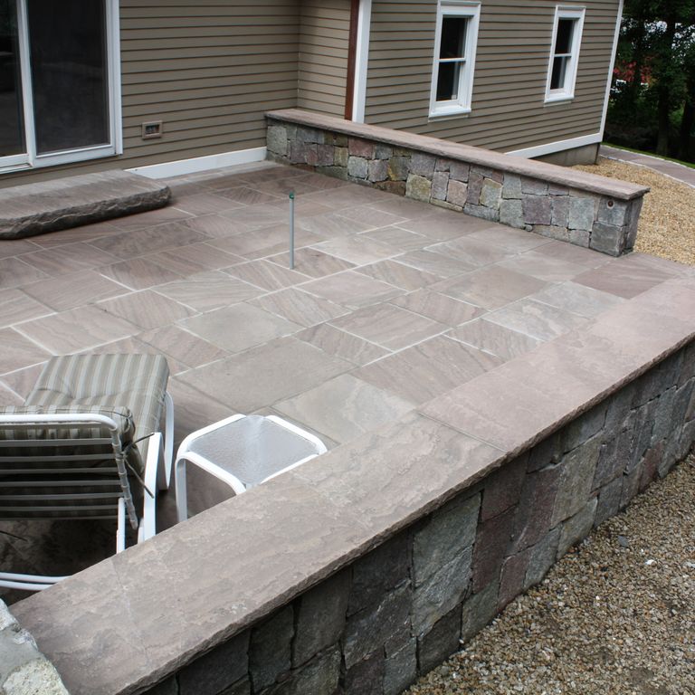 The image shows this material being used for wallstone cap, patio pavers and monolithic steps.