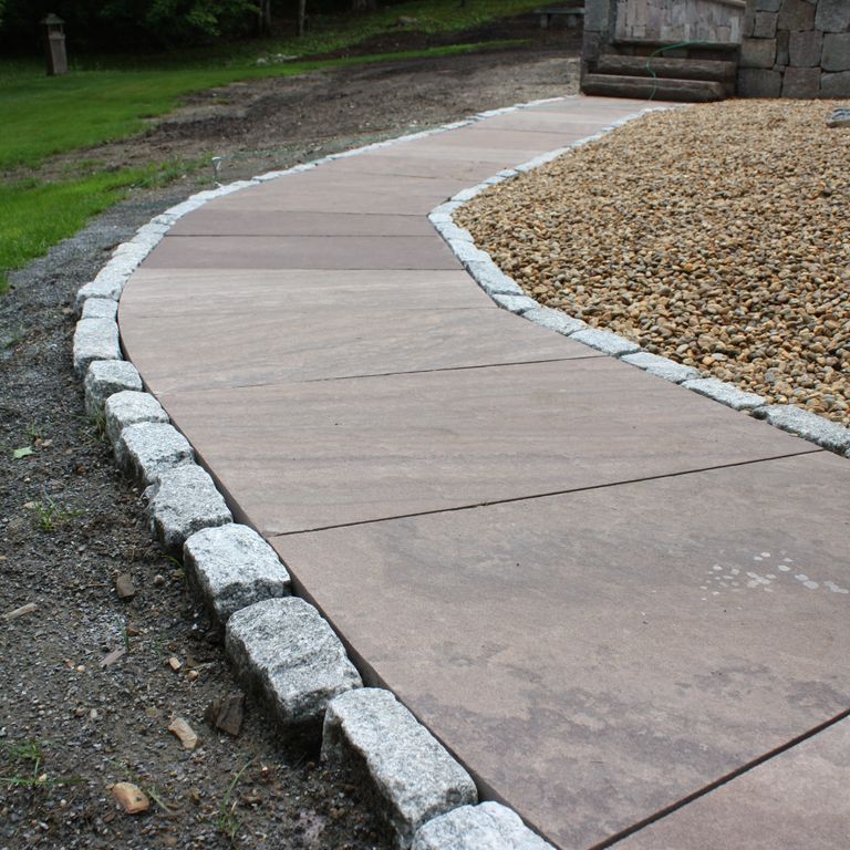 The image shows this material being used in a path pavers application.