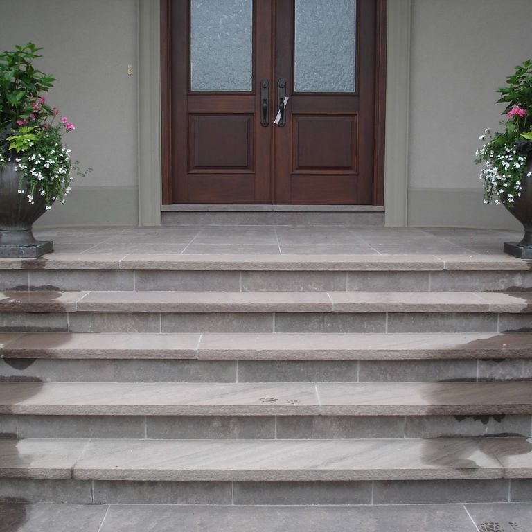 The image shows this material being used for patio pavers and treads.
