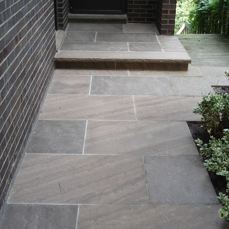 The image shows this material being used for patio pavers and treads.