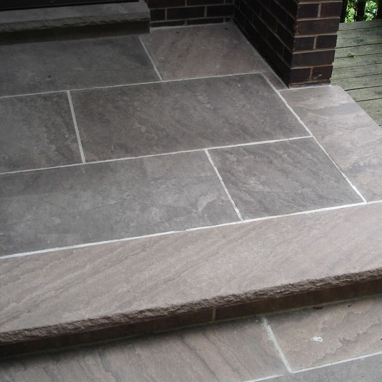 The image shows this material being used for patio pavers and treads.