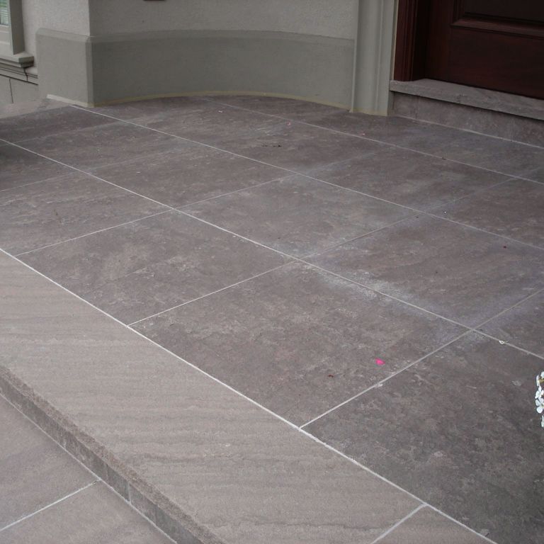 The image shows this material being used for patio pavers and treads.