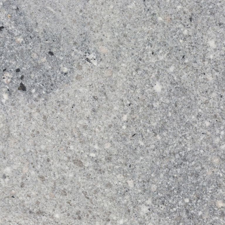 Close-up image for Fancy Blue Granite. The surface finish shown is honed. The dominant color shown is gray; with beige and white secondaries. Exhibits 
