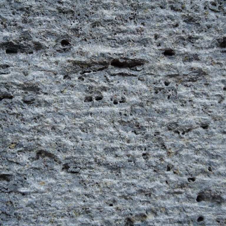 Color/Finish variation image for Ankar Lava Basalt. The surface finish shown is adze. Dominant colors shown are blue and gray; with black and green secondaries. The color mix creates a cool feeling. Linear, random and cloudy color patterns.