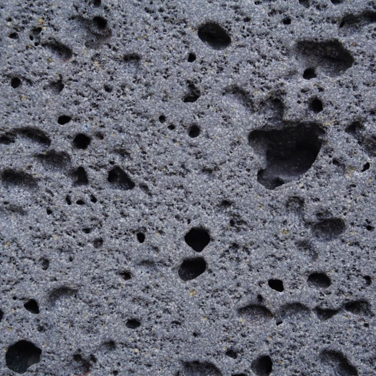 Color/Finish variation image for Ankar Lava Basalt. The surface finishes shown are sand blasted and waterjet. Dominant colors shown are blue and gray; with black and purple secondaries. The color mix creates a cool feeling. Regular color pattern.