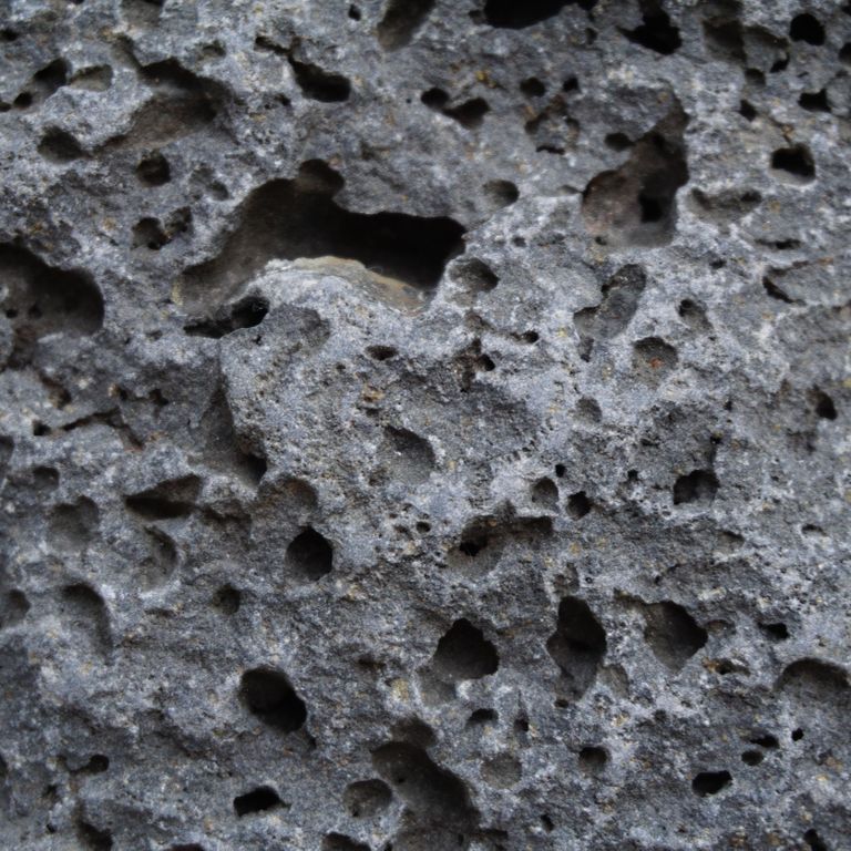 Color/Finish variation image for Ankar Lava Basalt. The surface finishes shown are split-face and tumbled. Dominant colors shown are black and gray; with blue and brown secondaries. The color mix creates a cool feeling. Regular color pattern.