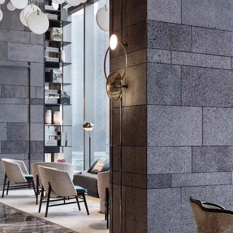 Feature image for Ankar Lava Basalt. The image shows this material being used for full bed veneer and thin veneer. The dominant color shown is gray; with black, blue, brown and purple secondaries. The color mix creates a cool feeling. Speckled color pattern.