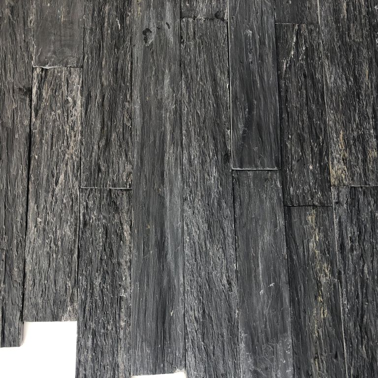 Color/Finish variation image for Black Schist. The surface finish shown is natural cleft. Dominant colors shown are black and gray; with a purple secondary. The color mix creates a cool feeling. Linear and blotched color patterns.