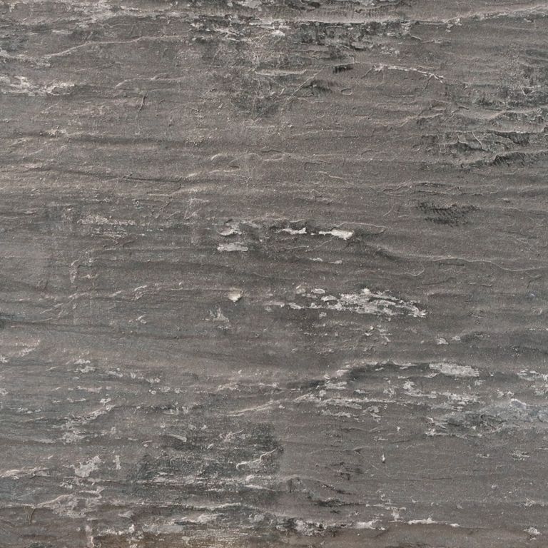 Best close-up image for Black Shale. The surface finish shown is a combination of natural and split-face. The dominant color shown is gray; with brown and purple secondaries. The color mix creates a cool feeling. Regular and linear color patterns.
