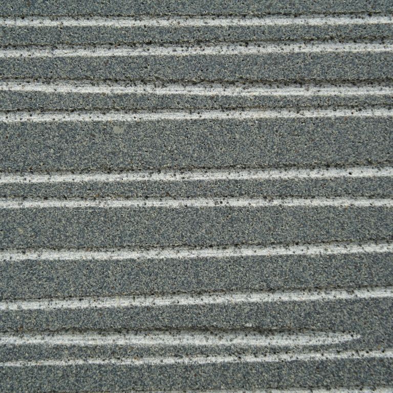 Color/Finish variation image for Ankar Gray Basalt. The surface finish shown is chiseled. Dominant colors shown are green and gray; with blue, brown and white secondaries. Exhibits 