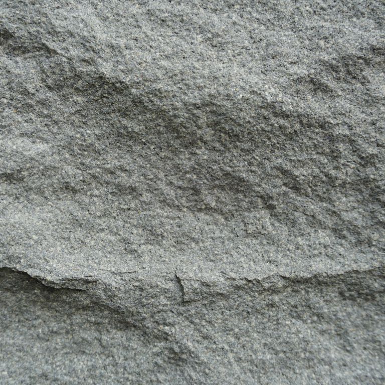 Color/Finish variation image for Basalt - Ankar Gray. The surface finish shown is rockfaced. The dominant color shown is gray; with a green secondary. Exhibits 