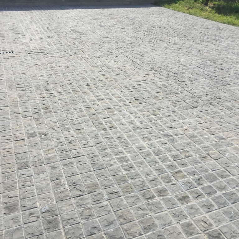 The image shows this material being used for driveway pavers and patio pavers.