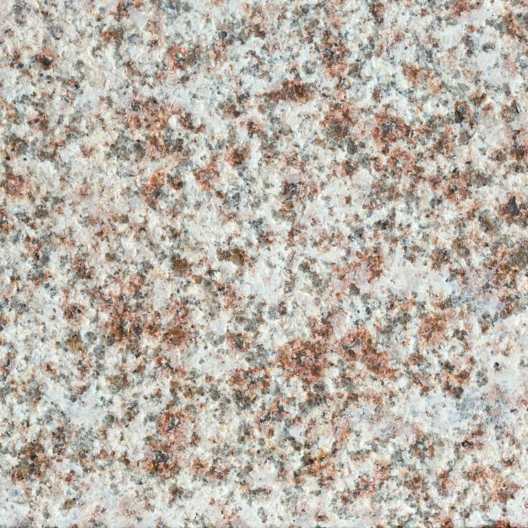 Best close-up image for Amber Granite - North. The surface finish shown is flamed. Dominant colors shown are gray, orange/rust and white; with beige, brown, pink, tan and cream secondaries. The color mix creates a warm feeling. Blotched and coarse speckled color patterns. Contains some mica and mineral inclusions.