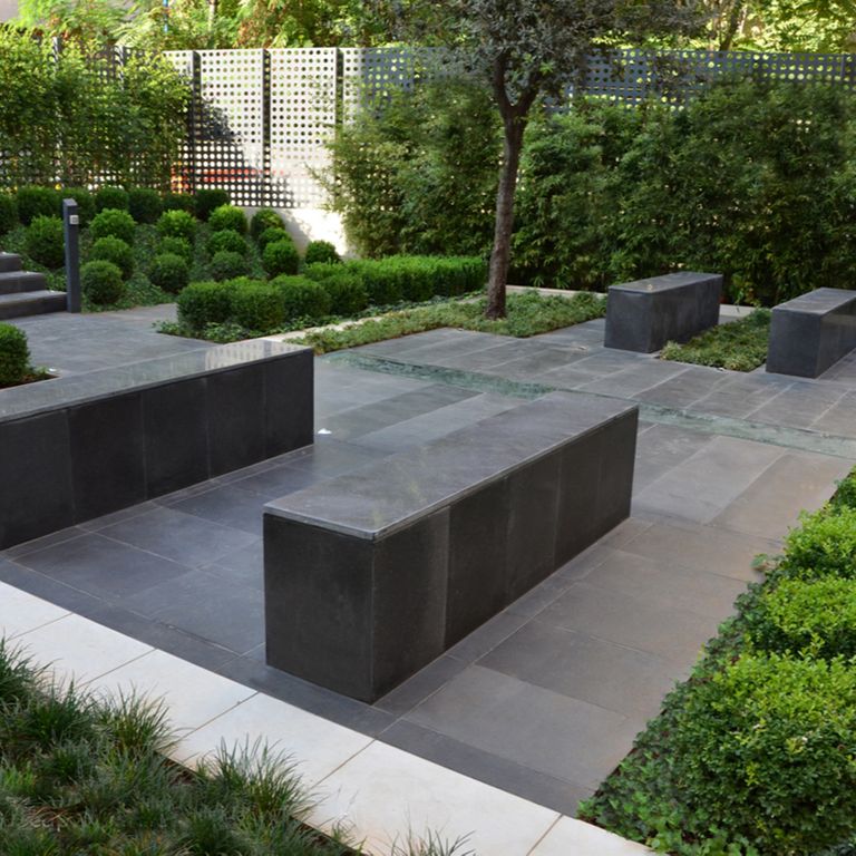 Feature image for Limestone - Belgian Bluestone. The image shows this material being used for seating & benches, patio pavers and treads. The surface finish shown is flamed. Dominant colors shown are blue and gray; with a white secondary. The color mix creates a cool feeling. Regular color pattern.