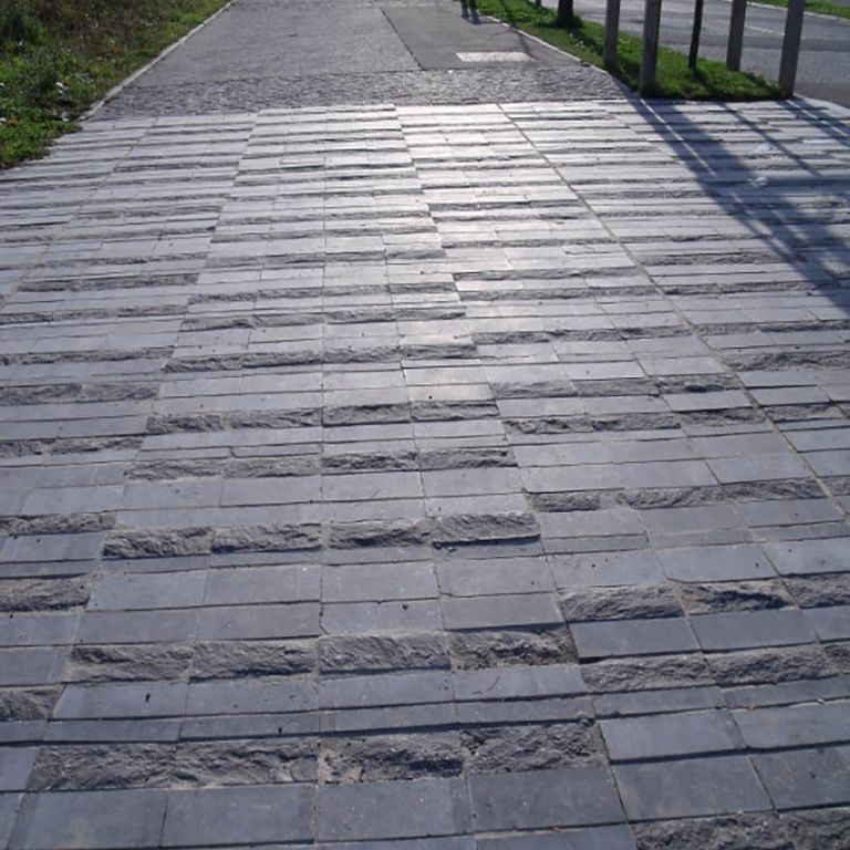 Application image for Limestone - Belgian Bluestone. The image shows this material being used in a path pavers application. The surface finish shown is flamed. Dominant colors shown are blue and gray. Regular color pattern.