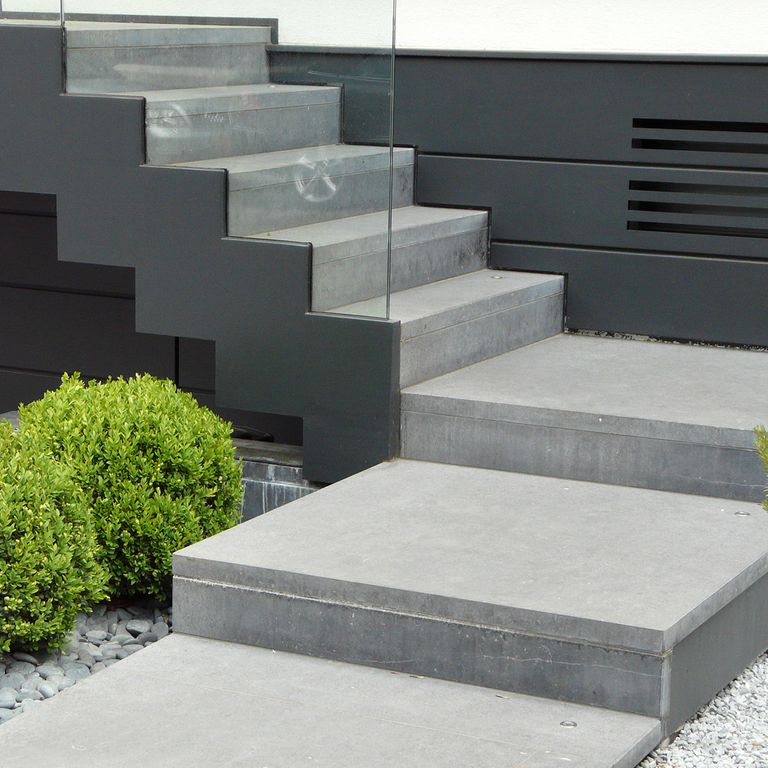 Application image for Limestone - Belgian Bluestone. The image shows this material being used for path pavers, landings and treads. The surface finish shown is sand blasted. The dominant color shown is gray. The color mix creates a warm feeling. Solid color pattern.