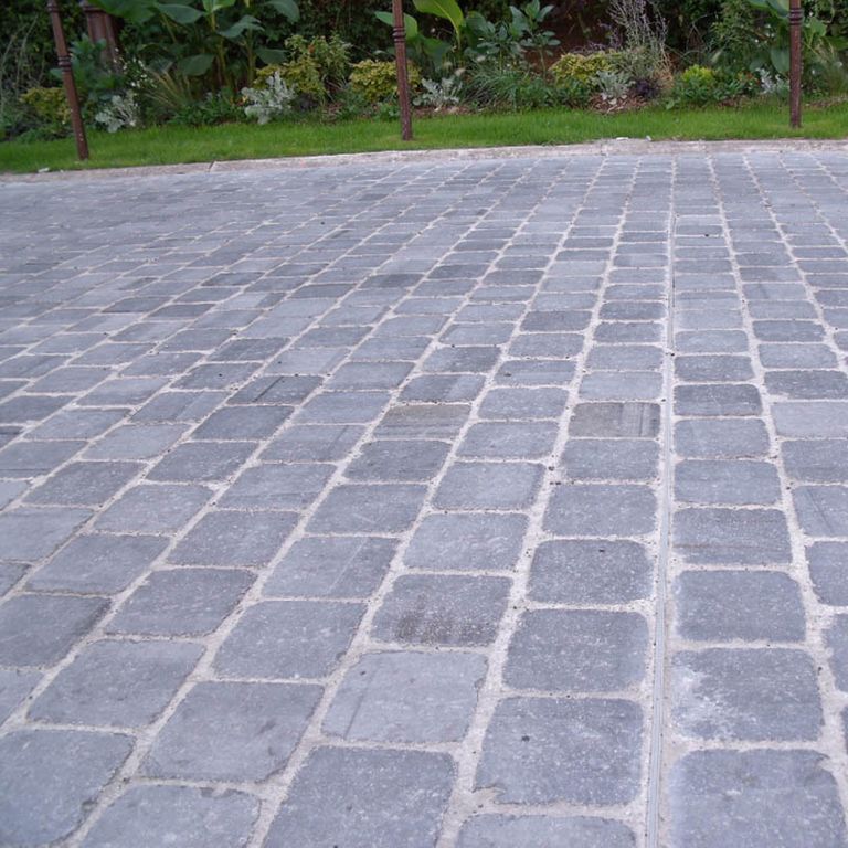 Application image for Limestone - Belgian Bluestone. The image shows this material being used in a driveway pavers application. The surface finish shown is . Dominant colors shown are blue and gray. Regular color pattern.