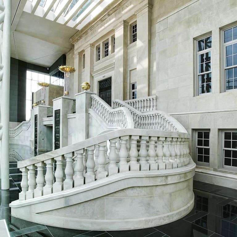 Feature image for Silver Shadow Limestone. The image shows this material being used for full bed veneer and thin veneer. Dominant colors shown are gray and white; with beige and cream secondaries. Exhibits 
