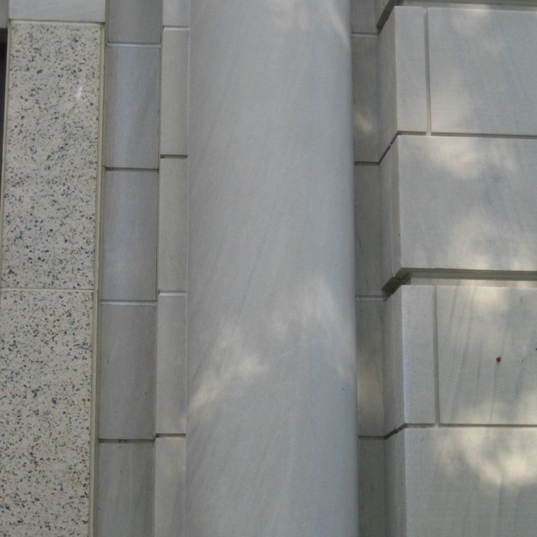 Application image for Silver Shadow Limestone. The image shows this material being used in a columns application. This is a building stone for indoor and outdoor commercial and residential applications. Suitable for general use, low heat absorption surfaces, low slipperiness surfaces and high heel compatibilty situations. Relatively higher in price.  This image has a Honed Finish.