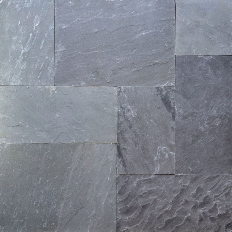 Best close-up image for Bluestone Natural Cleft - Blue/Gray. The image shows this material being used for full bed veneer and thin veneer. The surface finish shown is natural cleft. Dominant colors shown are blue and gray; with a green secondary. Exhibits 