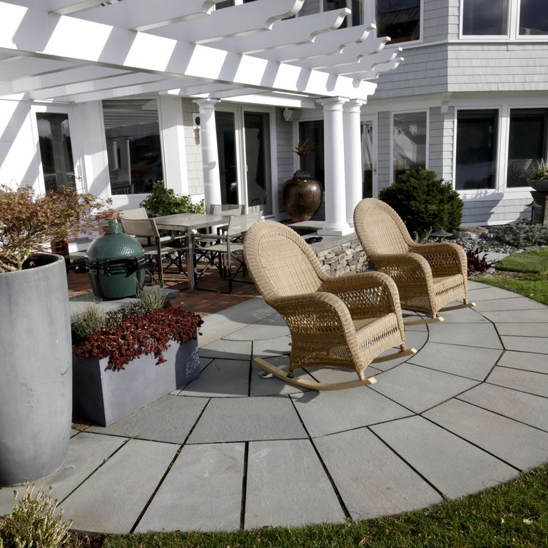 Feature image for Bluestone Flamed Surface - Blue/Gray. The image shows this material being used in a patio pavers application. The dominant color shown is gray. The color mix creates a cool feeling. Solid color pattern.