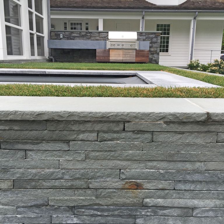Application image for Bluestone - Blue/Gray - Flamed Finish. The image shows this material being used for wallstone cap and landscape wallstone.