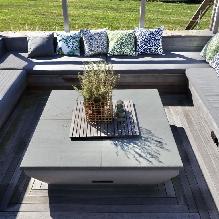 Application image for Bluestone Flamed Surface - Blue/Gray. The image shows this material being used in an outdoor fire concepts application. The surface finish shown is flamed. Dominant colors shown are blue and gray. The color mix creates a cool feeling. Solid color pattern.