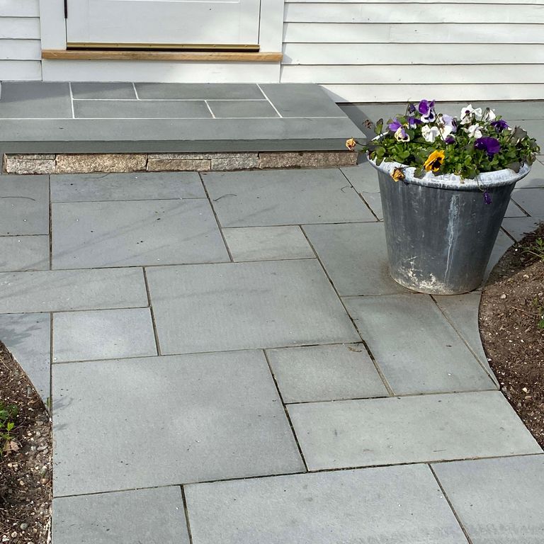 Application image for Bluestone - Blue/Gray - Flamed Finish. The image shows this material being used in a path pavers application.