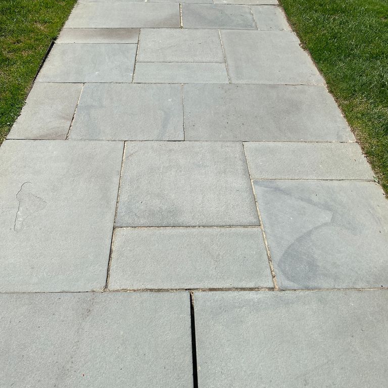 Application image for Bluestone - Blue/Gray - Flamed Finish. The image shows this material being used in a path pavers application.