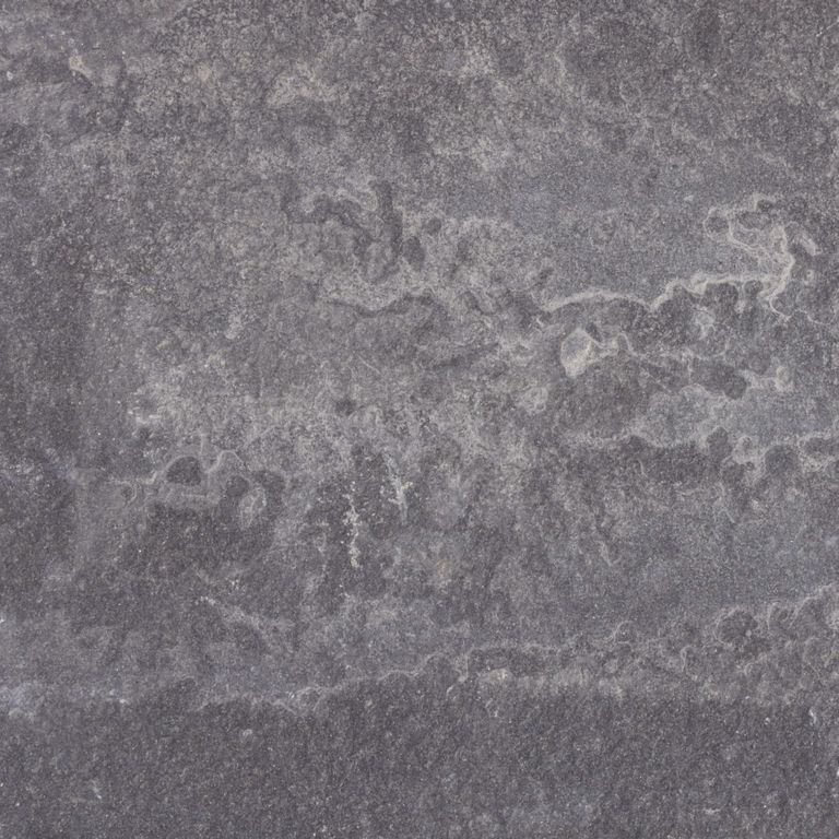 Close-up image for Bluestone Flamed Surface - Lilac. The surface finishes shown are brushed and flamed. Dominant colors shown are gray and purple. Exhibits 