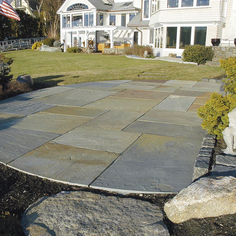 The image shows this material being used in a patio pavers application.