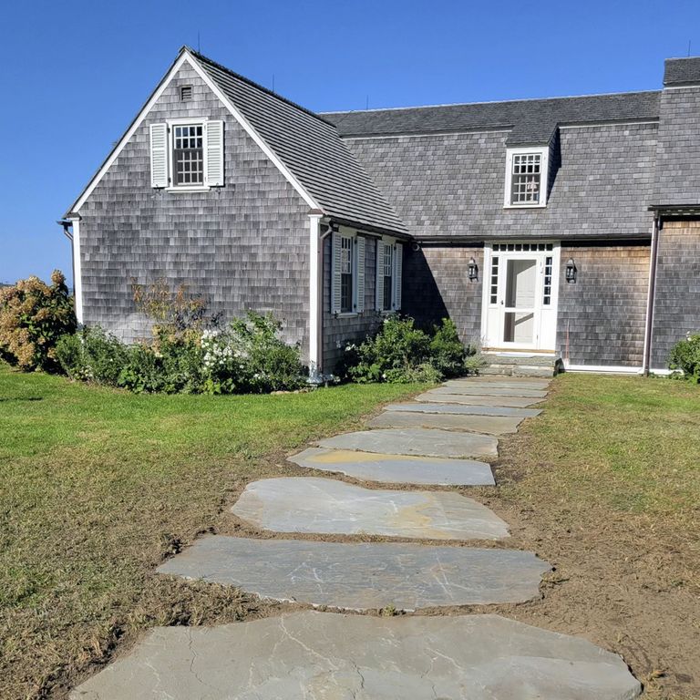 Application image for Bluestone Natural Cleft - Full Color Mix. The image shows this material being used in a path pavers application. The surface finish shown is natural cleft. The dominant color shown is gray. The color mix creates a warm feeling. Random color pattern.
